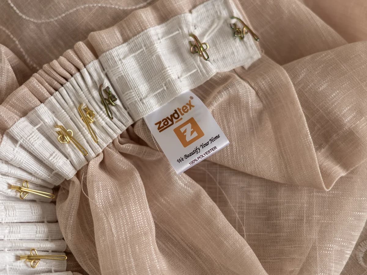 A Zaydtex ready-made curtain showing the taped header, hooks and branded Zaydtex label